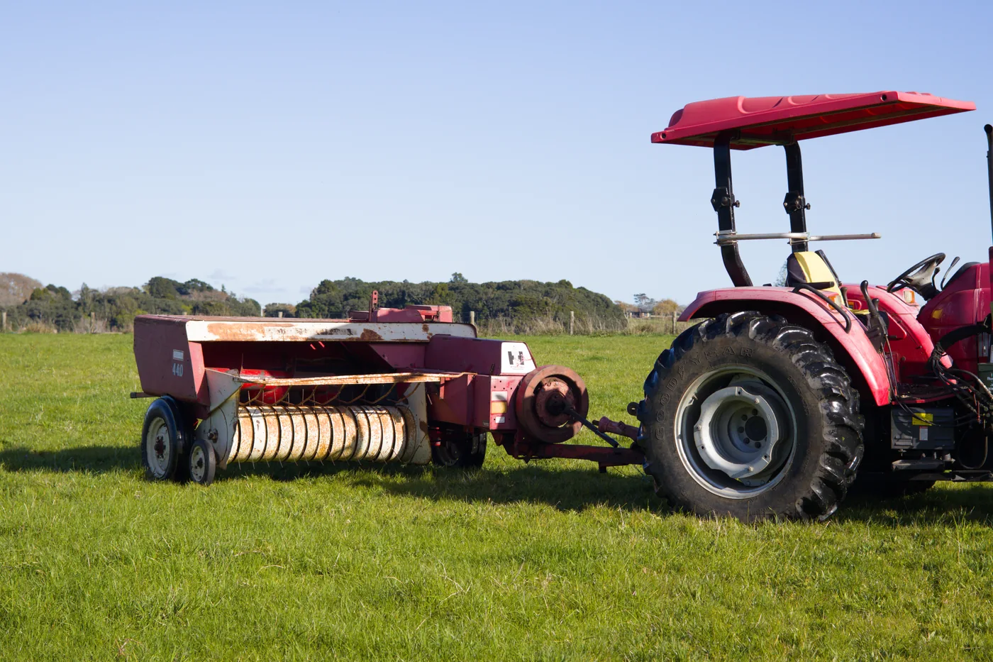 Tractor and baler in paddock